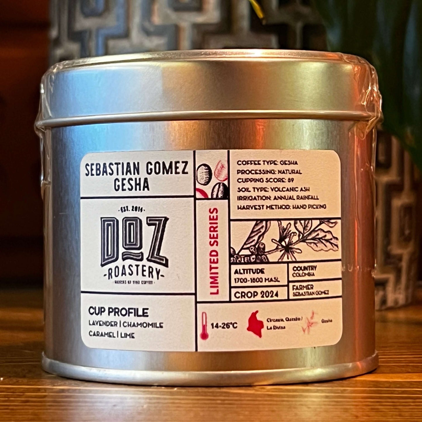 Silver tin of Sebastian Gomez Gesha coffee featuring detailed label with cup profile and processing information.