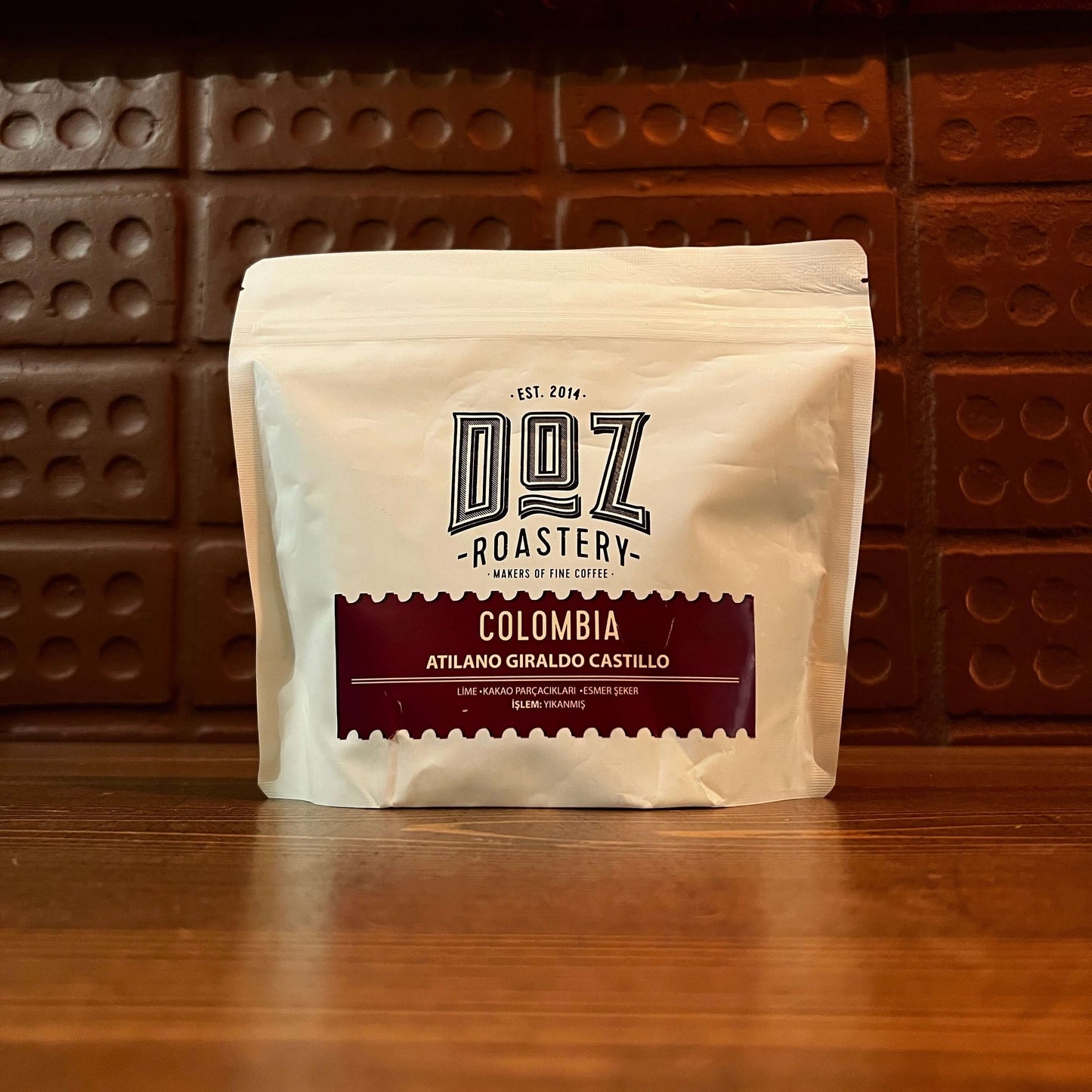Colombia Atilano Giraldo Castillo freshly roasted specialty coffee package on wooden table.