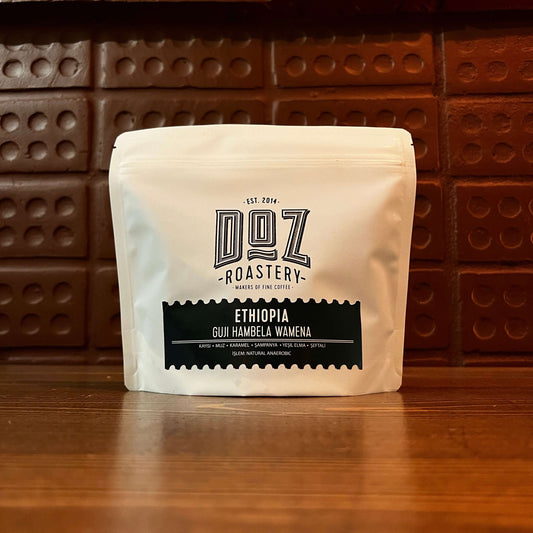 Ethiopia Wamena Natural Anaerobic Organic coffee from Doz Roastery with sustainable packaging on a wooden table.